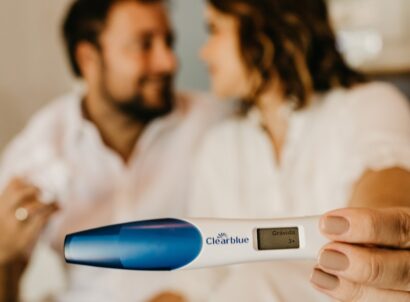 man in white dress shirt holding blue and white digital thermometer